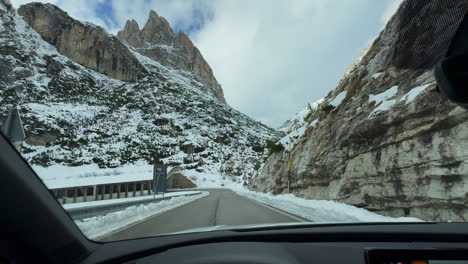 October-November-fall-autumn-winter-James-Bond-road-drive-through-tunnel-Dolomites-Italia-Italy-car-rental-jagged-rocky-mountain-side-stunning-Italian-Alps-countryside-daytime-blue-clear-skies-clouds