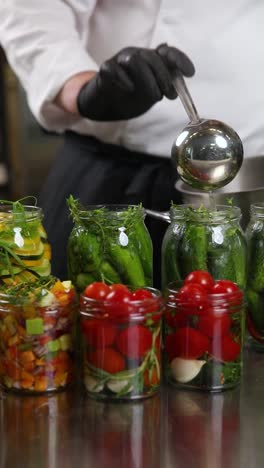 chef preserving vegetables in jars