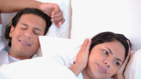 woman can not sleep because of her snoring husband