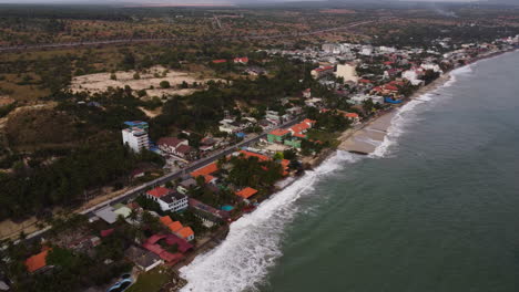 Aerial,-climate-change-rising-sea-levels-eroding-coastal-Southeast-Asia-village