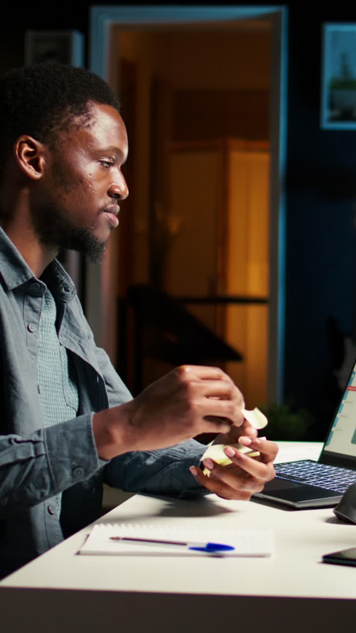 Man working on laptop at night