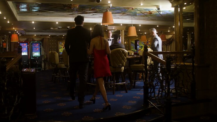 Multiethnic group of people joining the poker table in the casino.