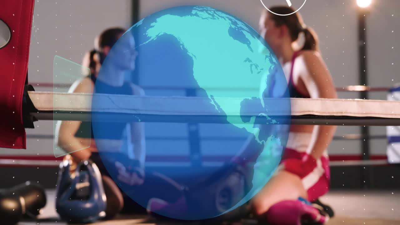Two boxers sitting in ring, holo globe appearing over them while wrapping and talking strategy