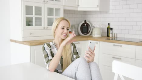 Charming-female-taking-selfie-in-kitchen