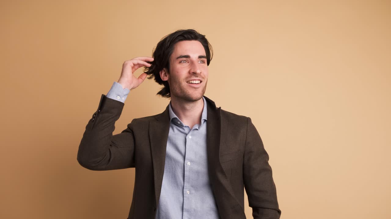 Thoughtful businessman with great idea in brown studio