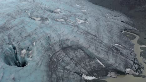 Aerial-flyover-breathtaking-Glacier-with-Edge-and-Ice-Caves-beside-volcano