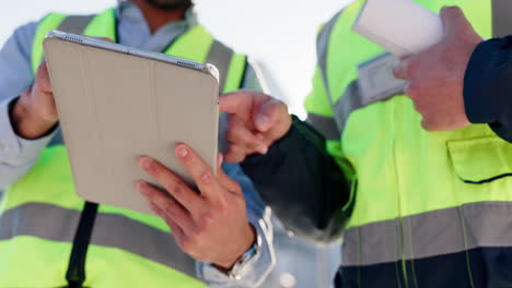 construction workers reviewing plans on tablet