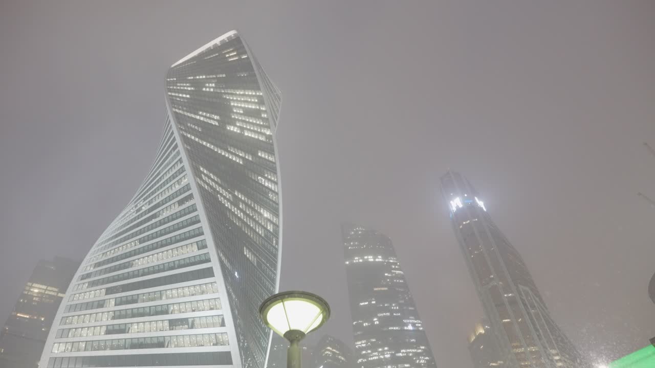 Modern Skyscrapers in a Foggy Night Cityscape