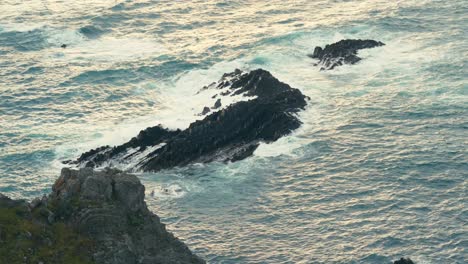 breaking rough waves on rocky islands. slow motion shot