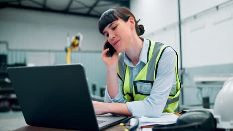 woman worker in a factory on a phone call and laptop