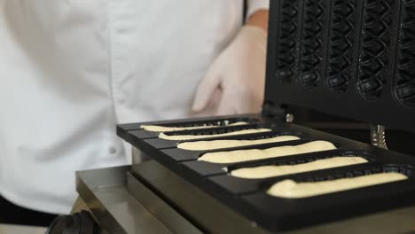 chef preparing hot dog waffles