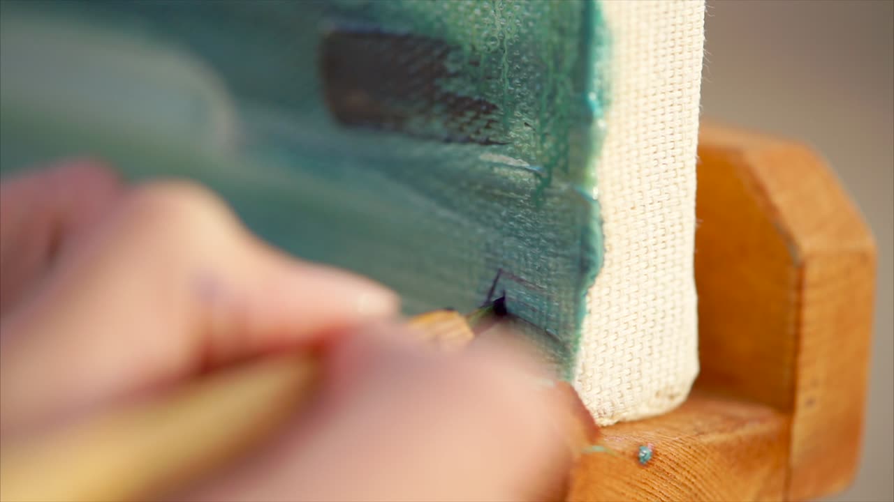 Artist Painting a Canvas Closeup