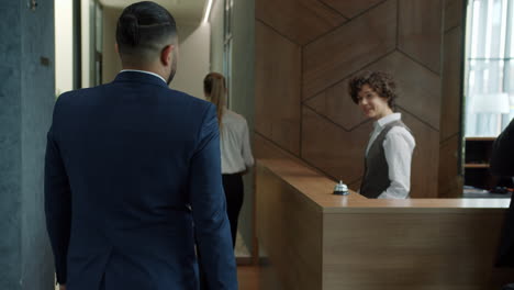 businessman checking in at hotel reception