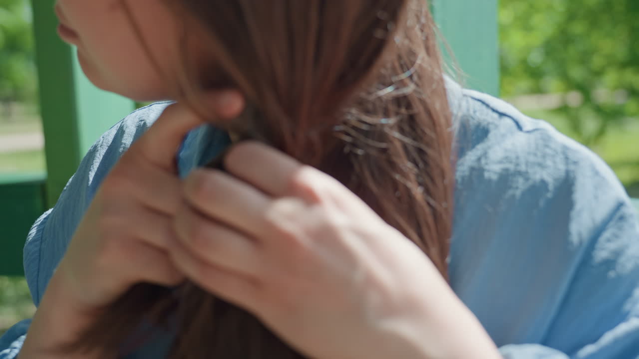 스타일링을 준비하는 여성, 땋을 머리를 정리하는 사람, 공원 벤치 근처에서 머리카락을 정리하는 백인 여성, 평화로운 공원 환경에서 머리카락을 정리하는 밝은 갈색 머리 여성
