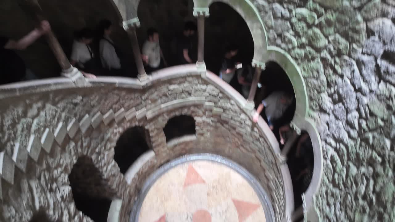 Looking up the mystical stone spiral of Quinta da Regaleira in Sintra, Portugal