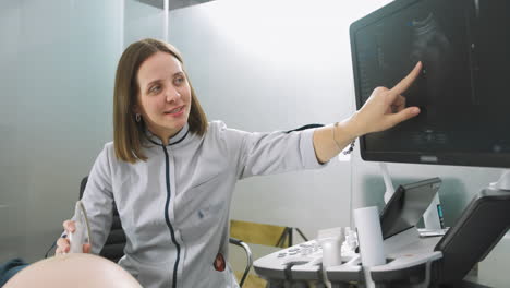 doctor performing an ultrasound scan on a pregnant woman
