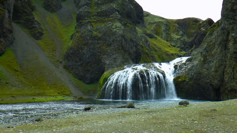 slow motion footage of small stjornarfoss waterfall in green canyon in south iceland