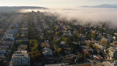 aerial view of early morning fog rolling in over a residential neighbourhood in vancouver