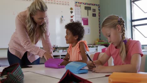 female teacher teaching kids in the class