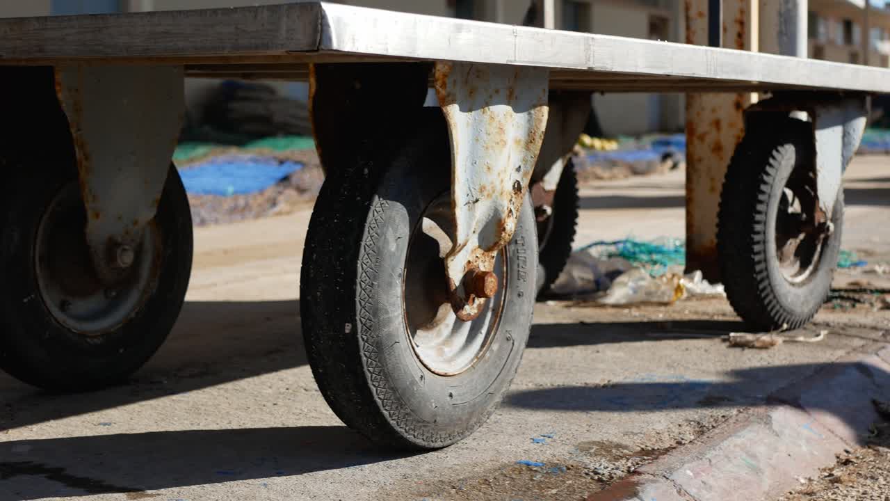 An old, wheeled cart used to transport small but heavy loads - low angle view