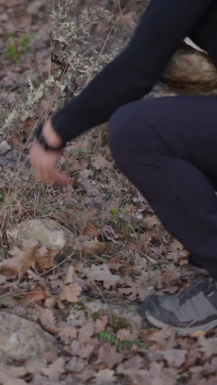 Person arranging rocks outdoors