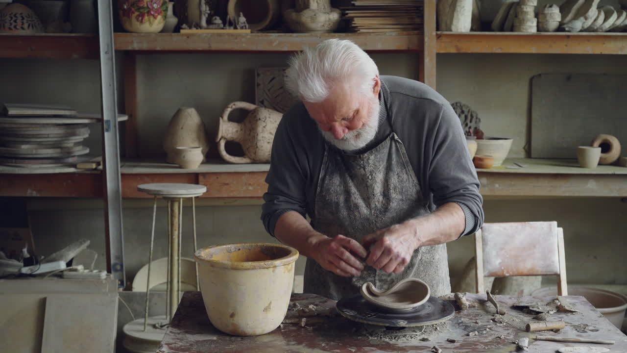 Senior Potter Working at Pottery Studio