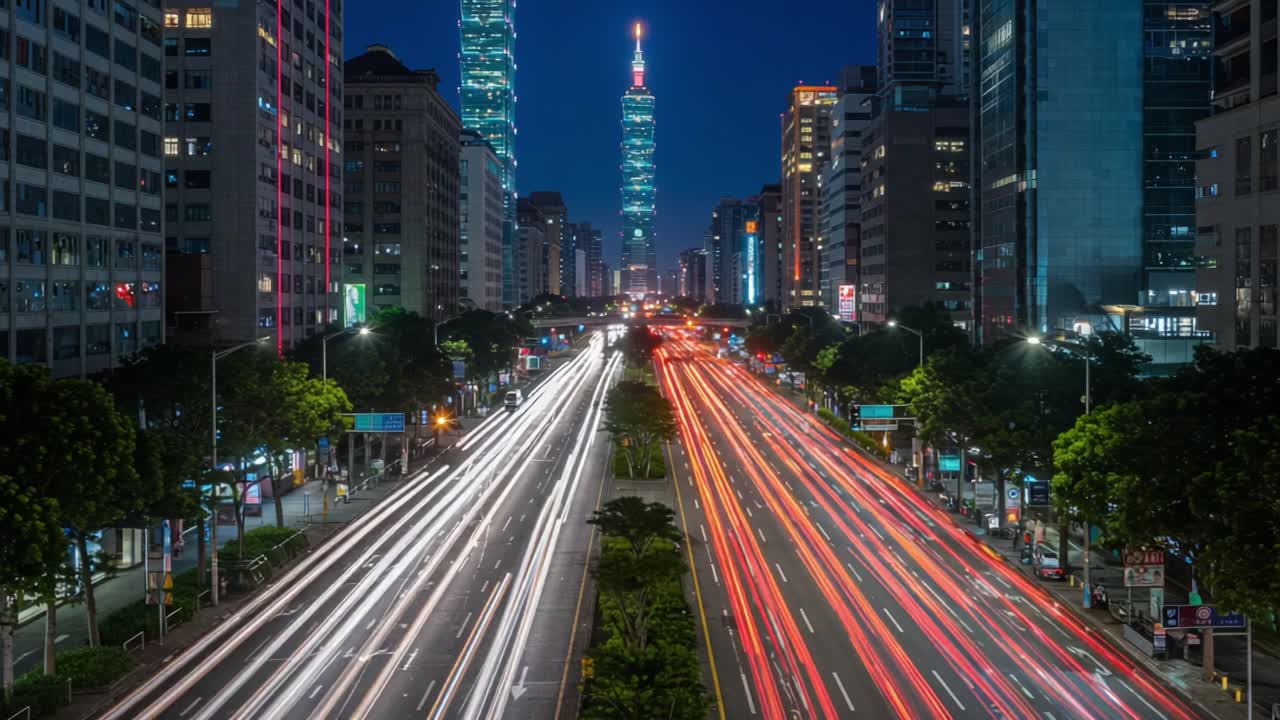 Captivating Nightscape of Urban Life: Glowing Traffic Flowing Through City Streets Beneath Towering Skyscrapers Bathed in Neon Lights Against a Dark Sky