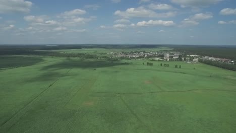 aerial view of a rural landscape with a town in the distance