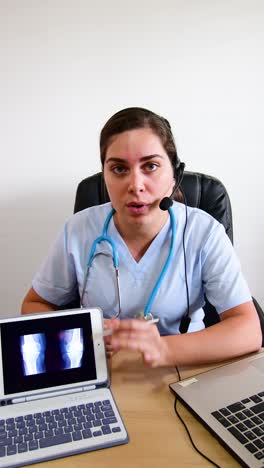 healthcare online. doctor traumatologist examines x-ray and legs.