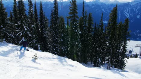 Person-snowboarding-on-snowy-mountain