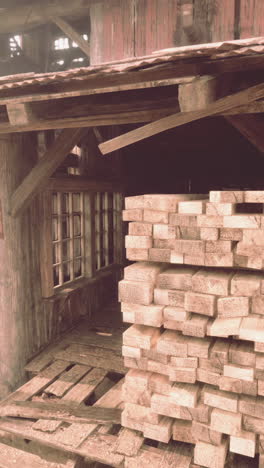 a pile of wood stacked inside a rustic shed