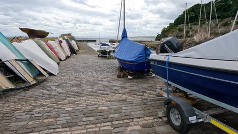 boats lined up along a cobblestone path