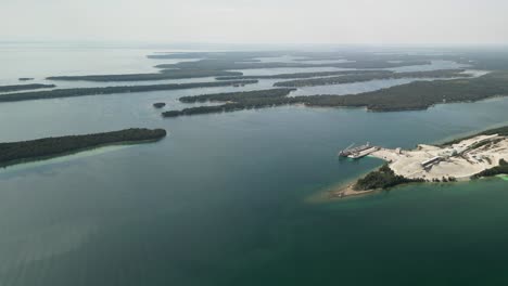 aerial pan of limestone quarry and les cheneaux islands, michigan