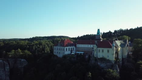 Chateau-Hruba-Skala-in-Bohemian-Paradise,-Czech-Republic,-Trosky-castle-in-the-distance,-Drone-view---orbiting-and-fly-down,-4k-or-UHD,-30fps
