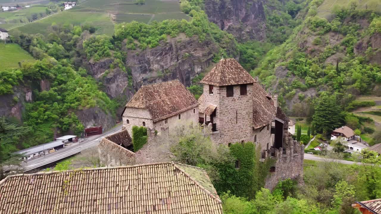 Ancient Roncolo castle building in Italy, aerial orbit view