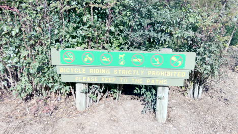 Caution-sign-on-entry-to-Ju-Raku-En-Japanese-Garden,-Toowoomba,-Australia