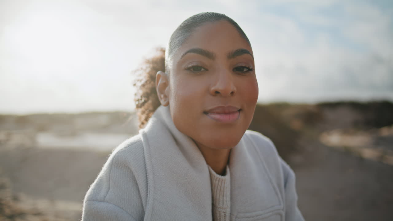 Portrait happy girl resting morning beach. Attractive african american looking