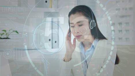 animation of data processing over biracial businesswoman using phone headphone in office