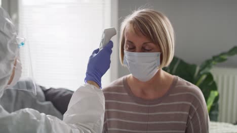 video of medical worker measuring the temperature of a senior