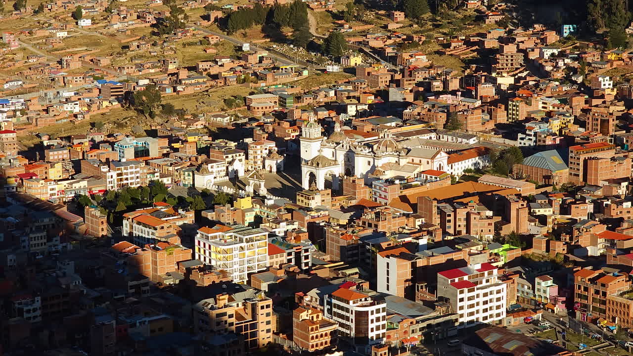 Experience a breathtaking aerial view of Copacabana, a vibrant tourist town in Bolivia, bathed in the warm glow of sunset