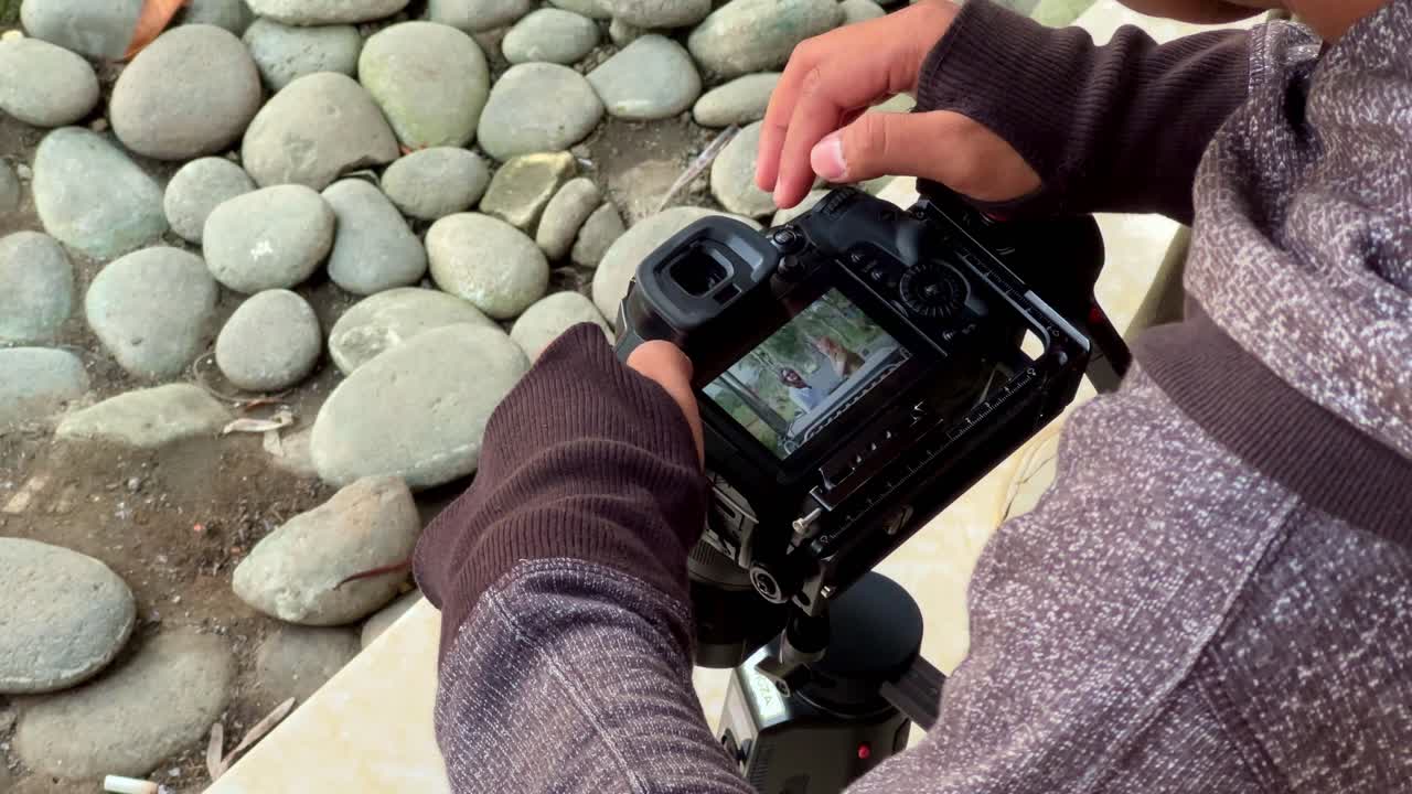 Hand off cameraman is holding and prepare the camera