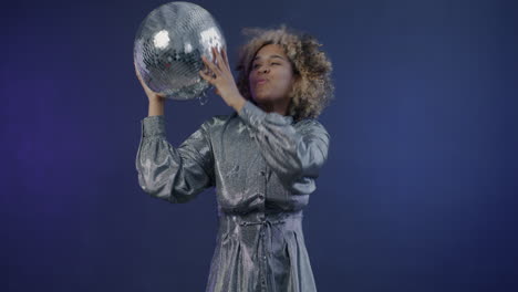woman dancing with disco ball
