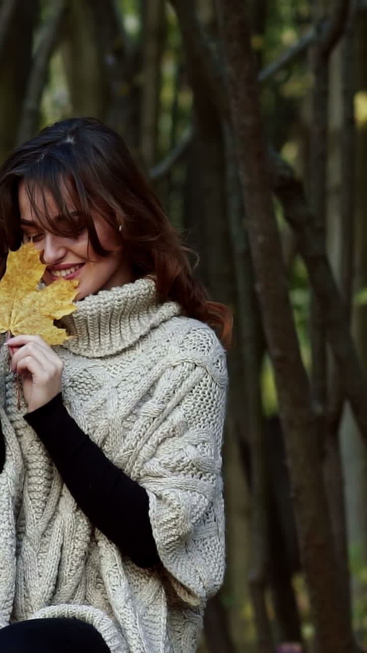 Beautiful female dreaming in the autumn park. Cheerful beautiful girl outdoors on beautiful fall day