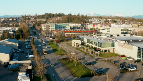 descending aerial toward a busy street on a late afternoon