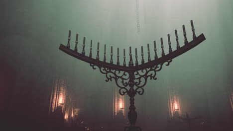 a gothic church interior with candlesticks and fog