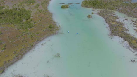 tourists on mexico holiday vacation kayaking in bacalar near los rapidos, aerial