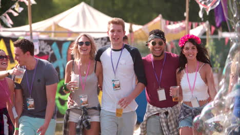 group of friends walking at a music festival, slow motion