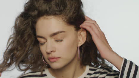 young woman doing skin care in studio