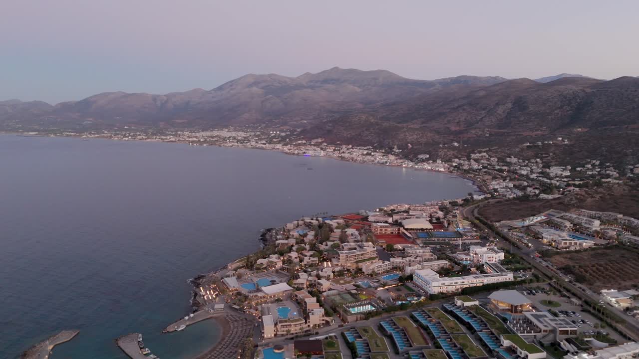Aerial view of Chersonissos hotels overlooking the bay towards Malia village, Crete
