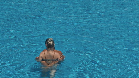 beautiful girlfriends having fun in swimming pool